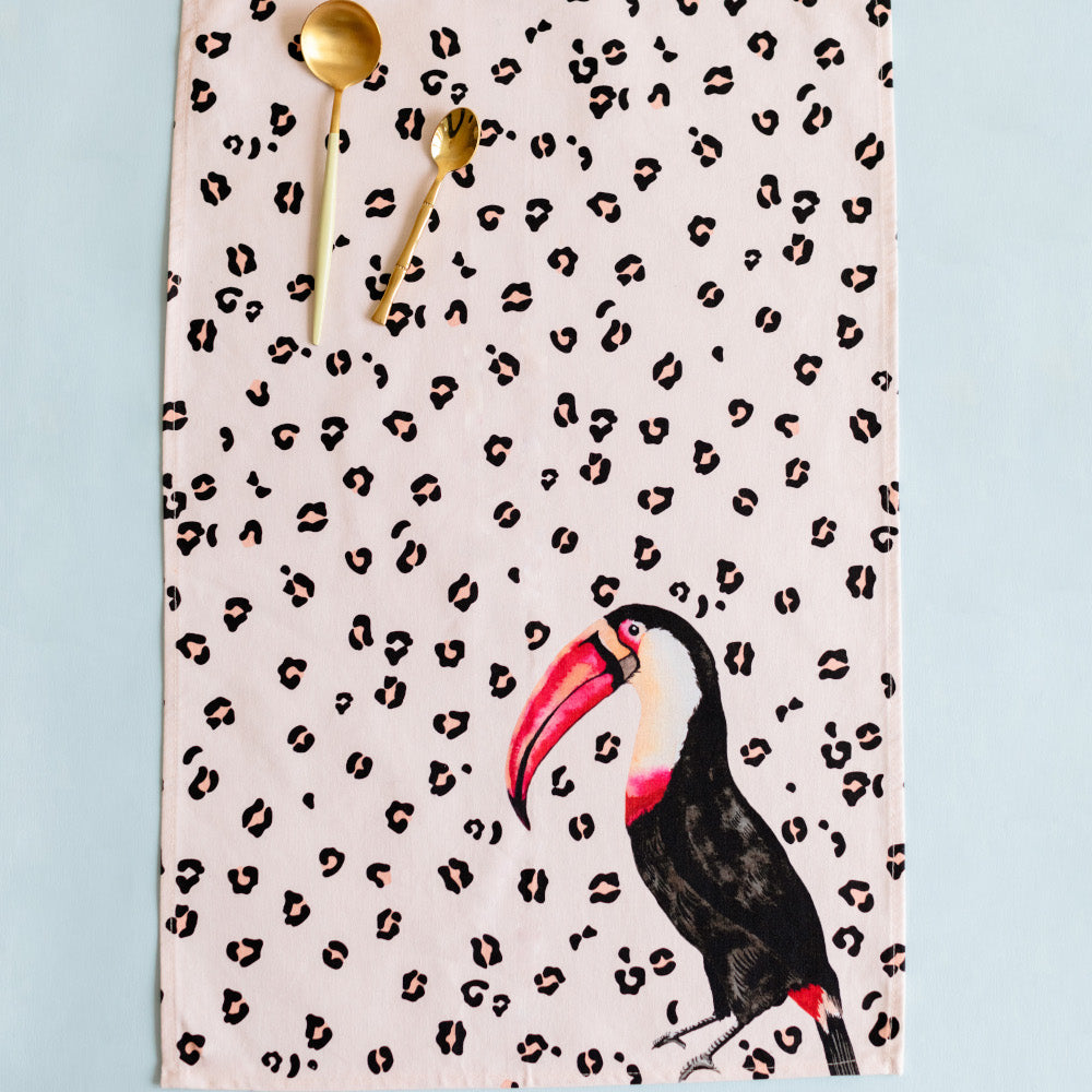 Toucan tea towel with two gold spoons